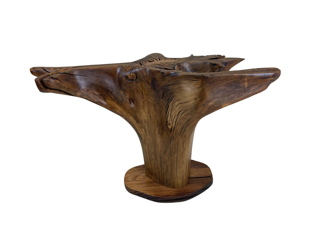 An oak tree stump dining table with out a glass top against a solid white background.