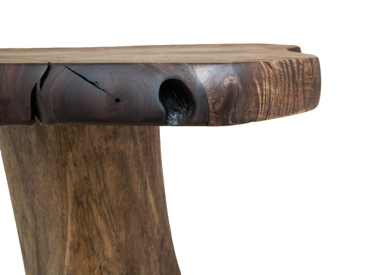 Close up of a Black Walnut live edge slab on a console table featuring a knot hole, cracks, and grain patterns.
