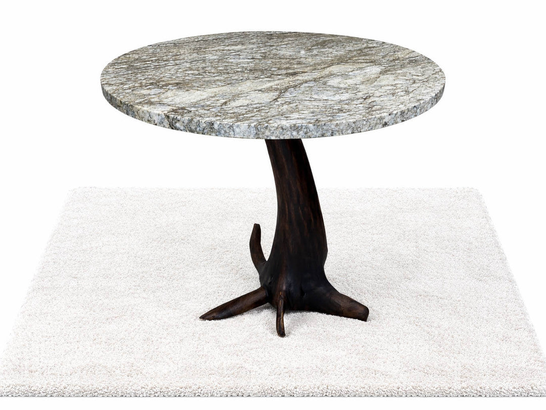 Round granite top dining table featuring root structure base of a black walnut tree