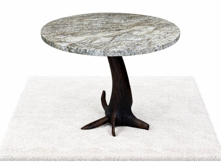 Round granite top dining table featuring root structure base of a black walnut tree