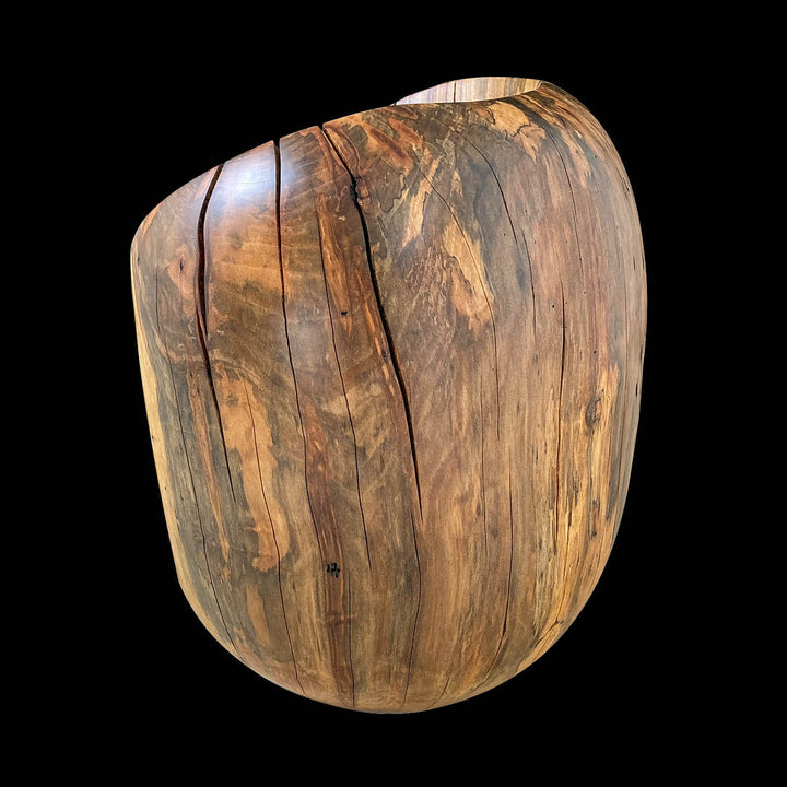 Back side of solid sycamore chair showing grain patters and natural oil finish.  Black background.
