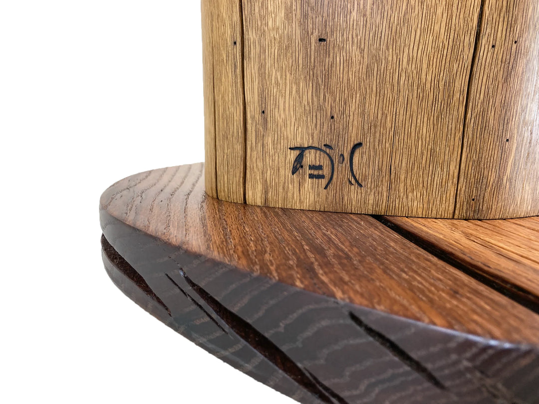 Brand icon of Matt Kruse on the wood side of a table.