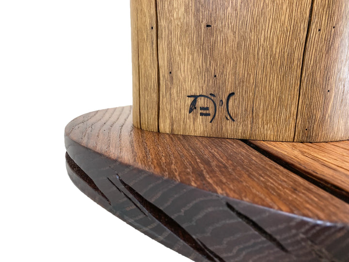 Brand icon of Matt Kruse on the wood side of a table.