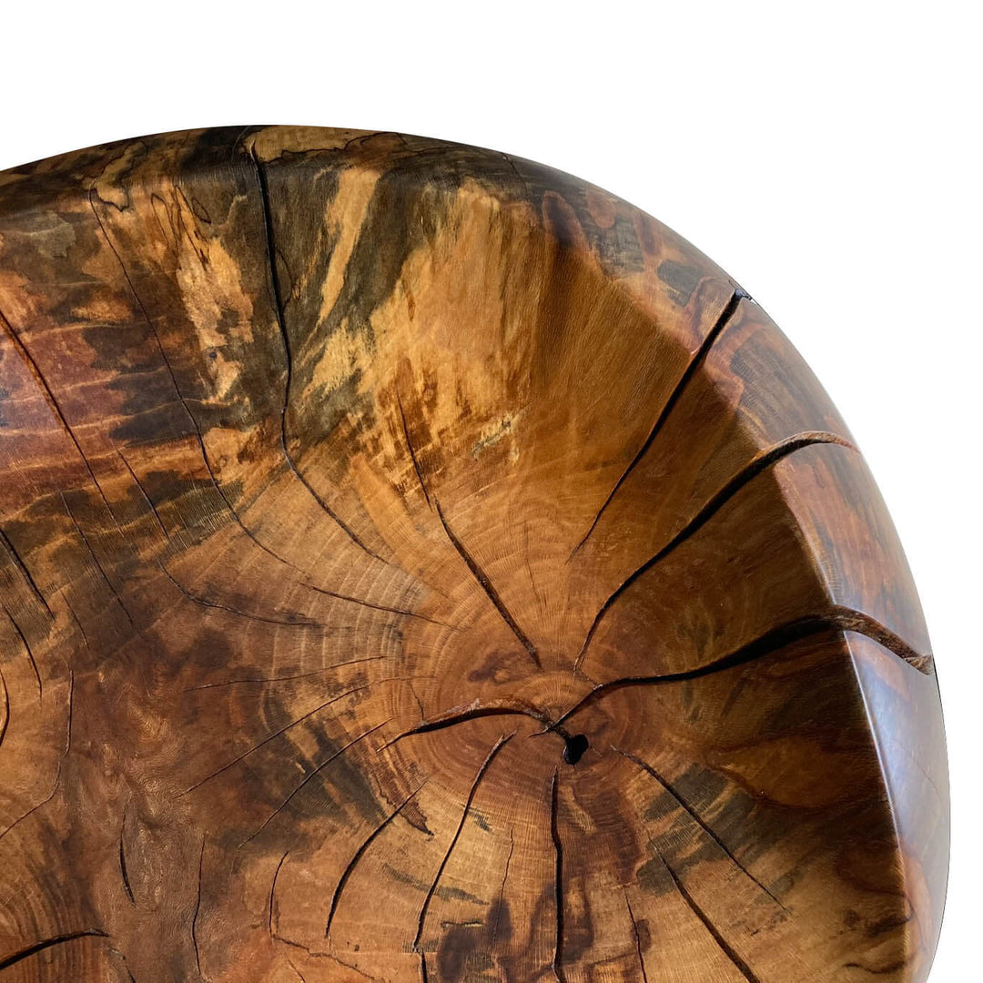 Close-up of seat area of a solid sycamore chair showing grain patters and natural oil finish.  White background.