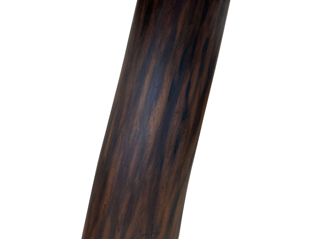 Close-up of a dark black walnut tree pedestal to support the table top with a white background
